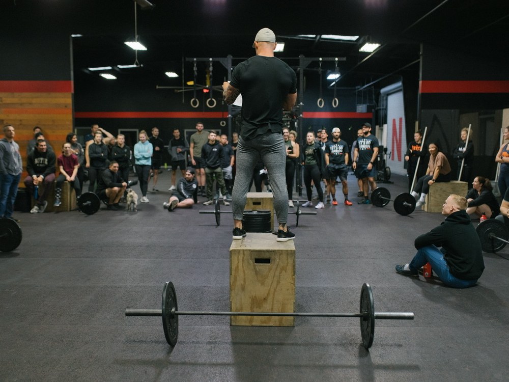 A group fitness community cheering on an athlete